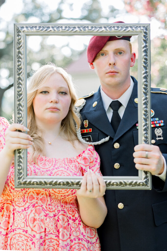 Couple mimicking the American Gothic portrait during their engagement session at Gillis Hill Farm