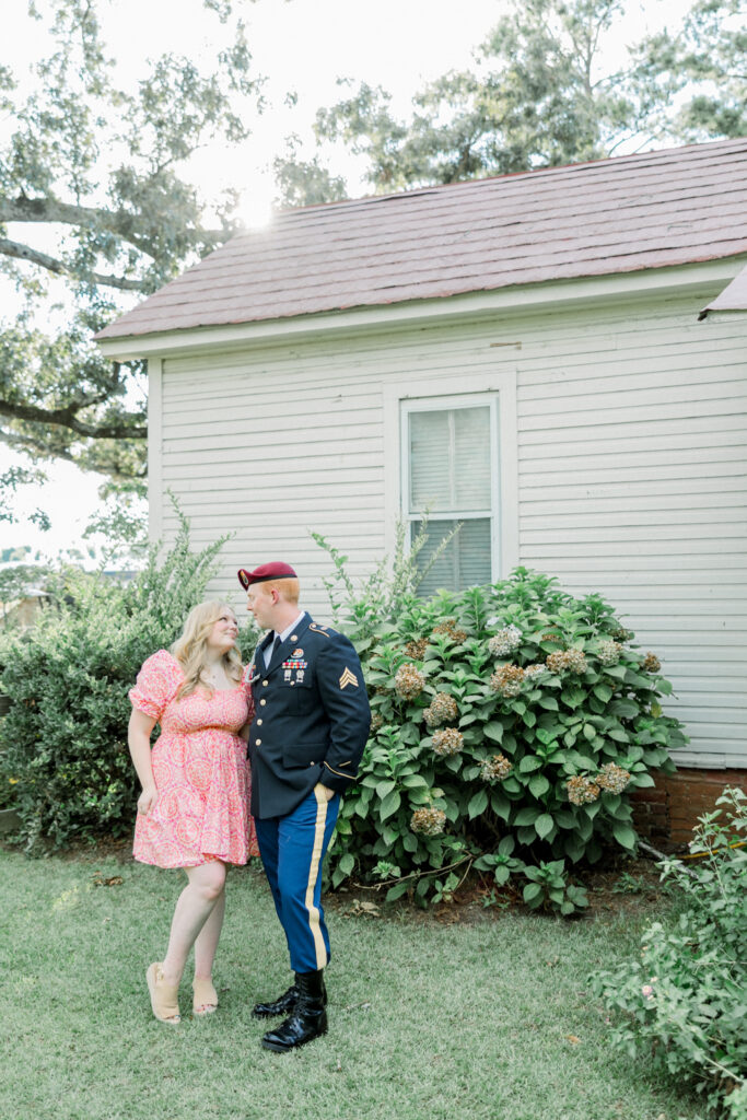 Couple standing together at Gillis Hill Farm in Fayetteville, NC during their rustic summer engagement session.