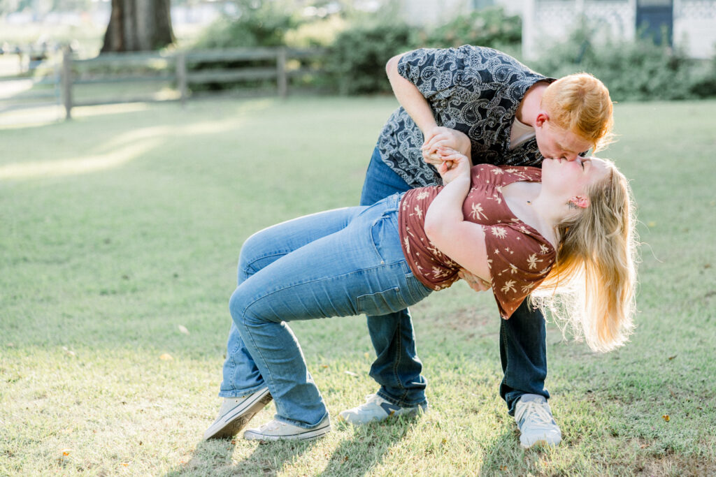 Bride-to-be and fiancé practicing their first dance and dip kiss during their summer engagement session in Fayetteville, North Carolina