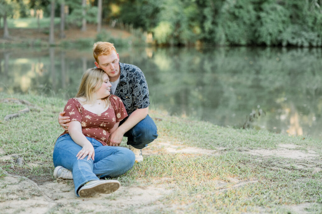 Couple holding one another down by the lake at Gillis Hill Farm in Fayetteville, North Carolina