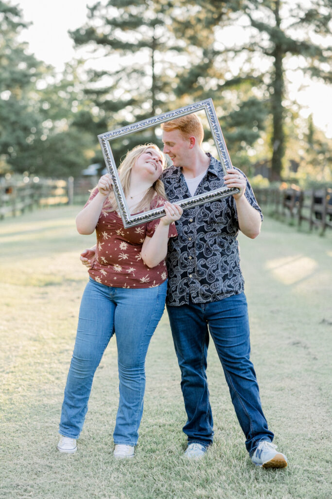 Couple standing together at Gillis Hill Farm in Fayetteville, NC during their rustic summer engagement session.