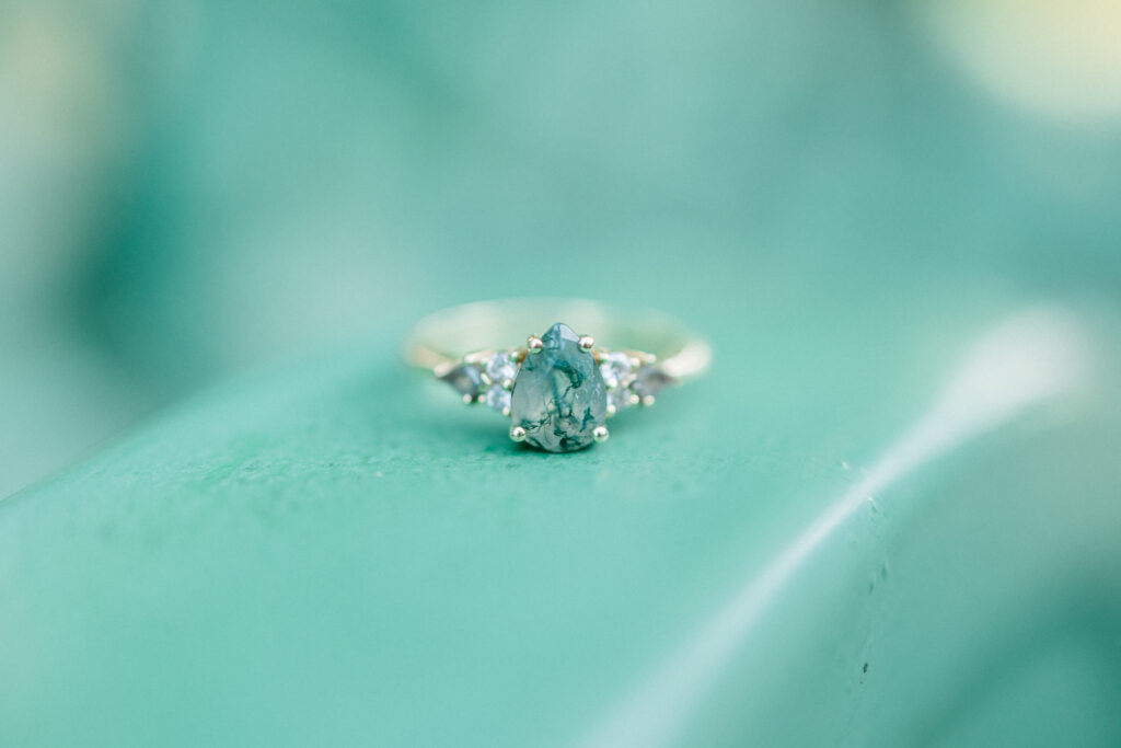 Close-up of engagement ring on tractor at Gillis Hill Farm engagement session.