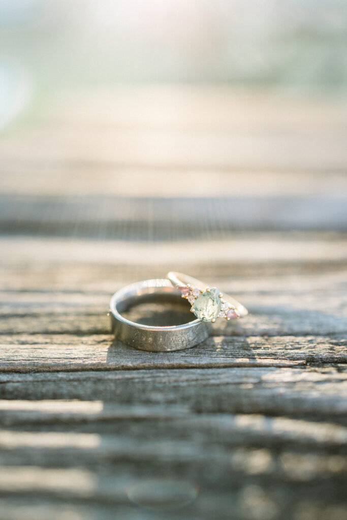 Close-up of engagement ring and fiancé’s ring with a sunset glow at Gillis Hill Farm engagement session.