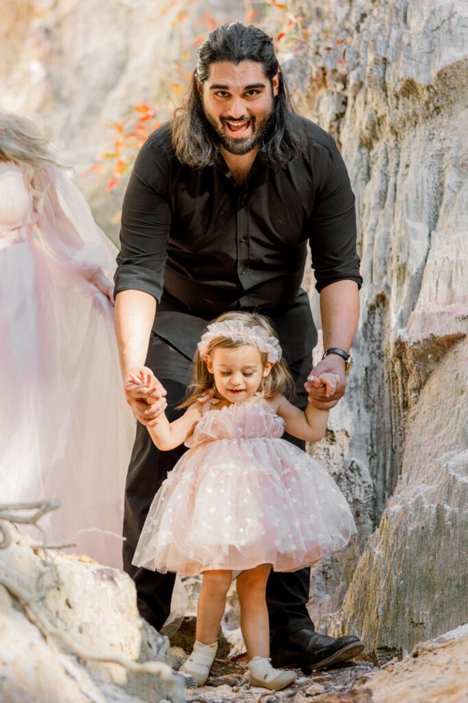 Father and daughter smiling during family photo session