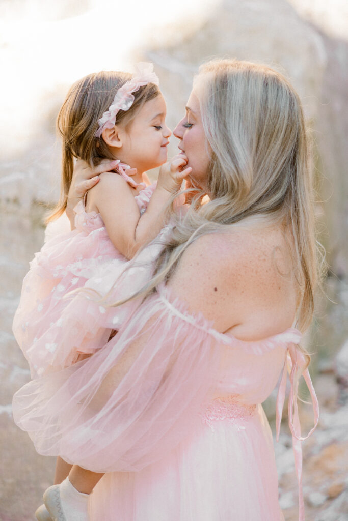 Mother and daughter smiling during family photo session