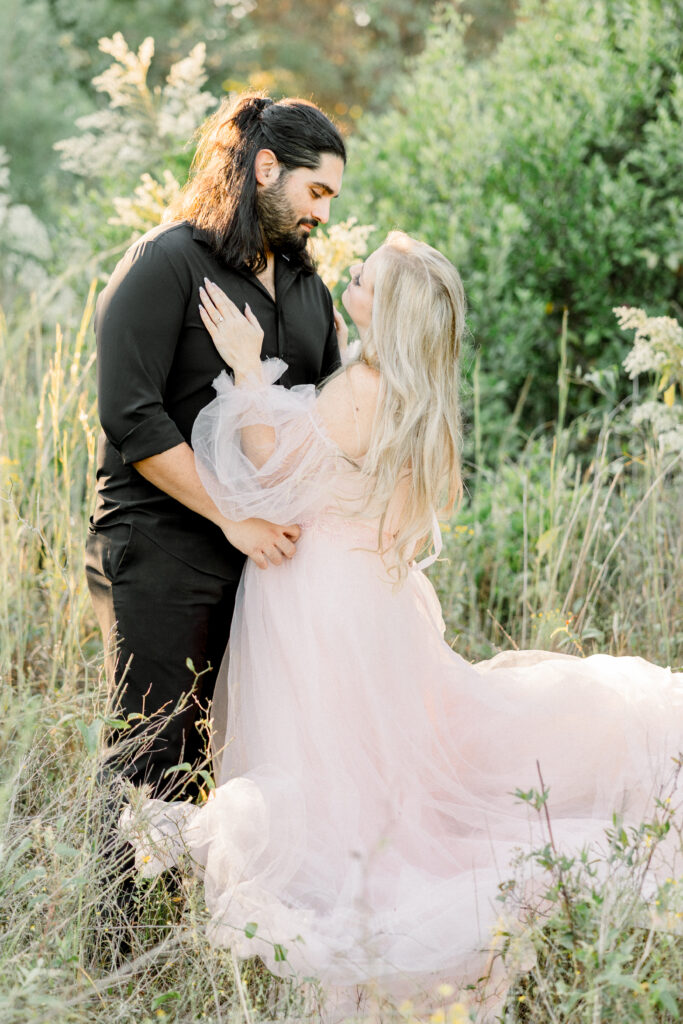 Couple portraits in a sunset golden field with wild grass