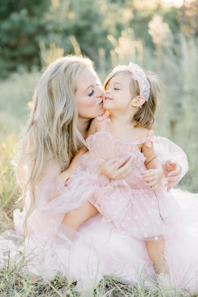 Mother and daughter smiling during family photo session