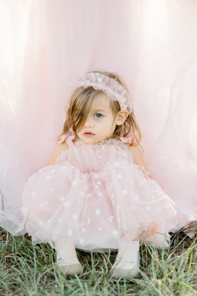Toddler in pink dress with mother in pink dress