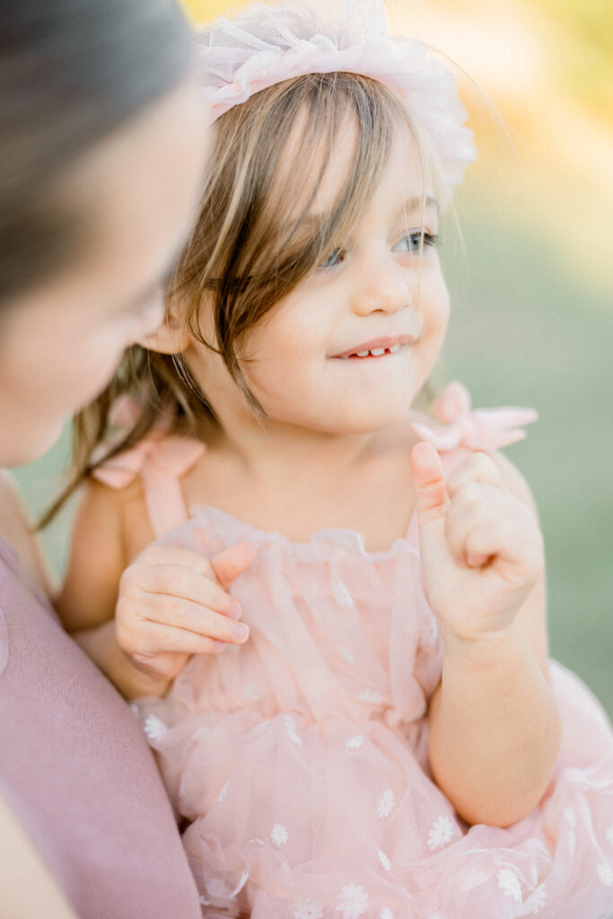 Candid toddler smiles during family portraits