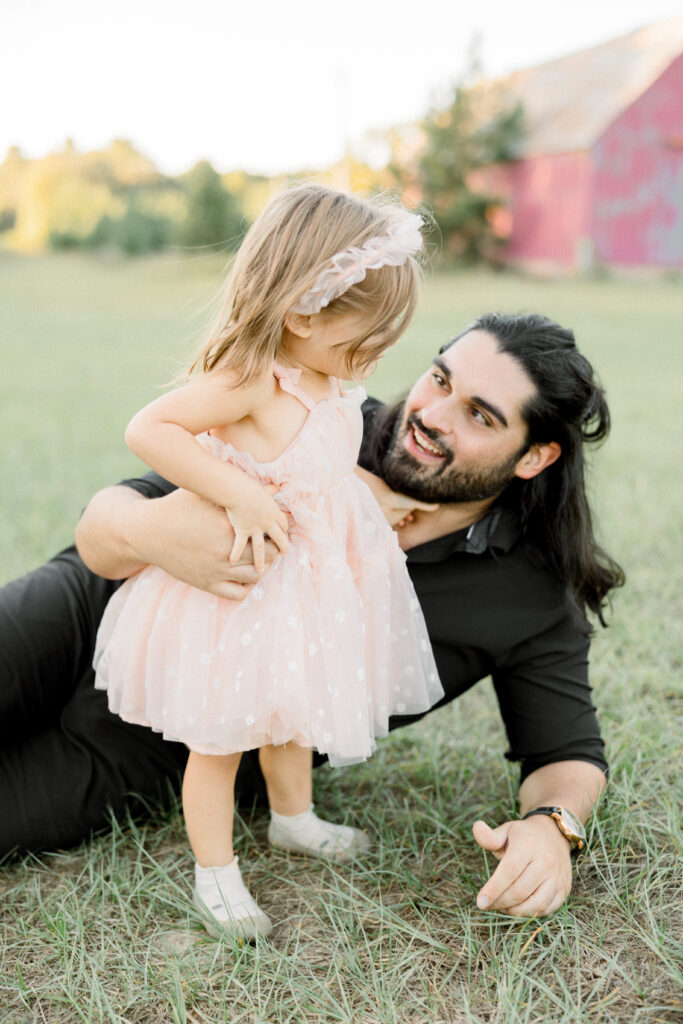 Father and daughter smiling during family photo session