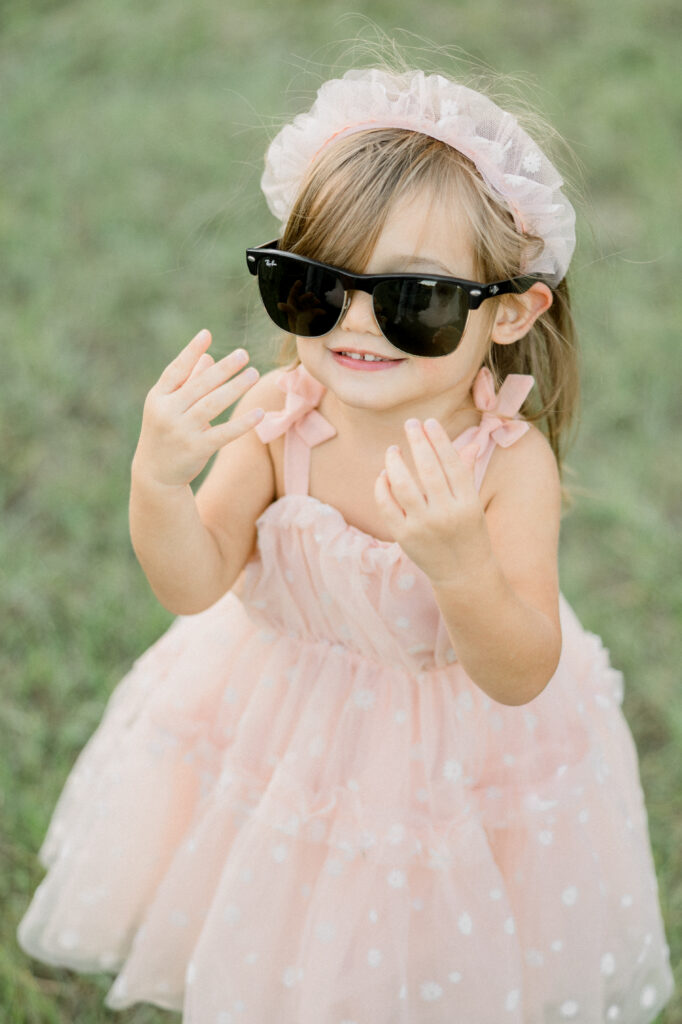 Toddler wearing sunglasses during family portrait
