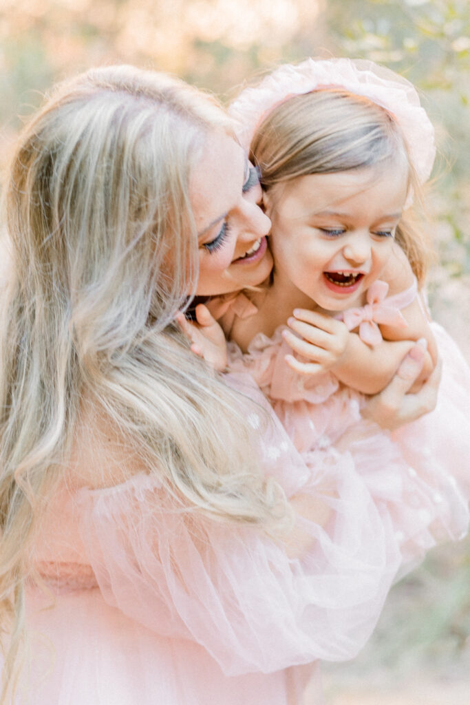 Mother and daughter smiling during family photo session